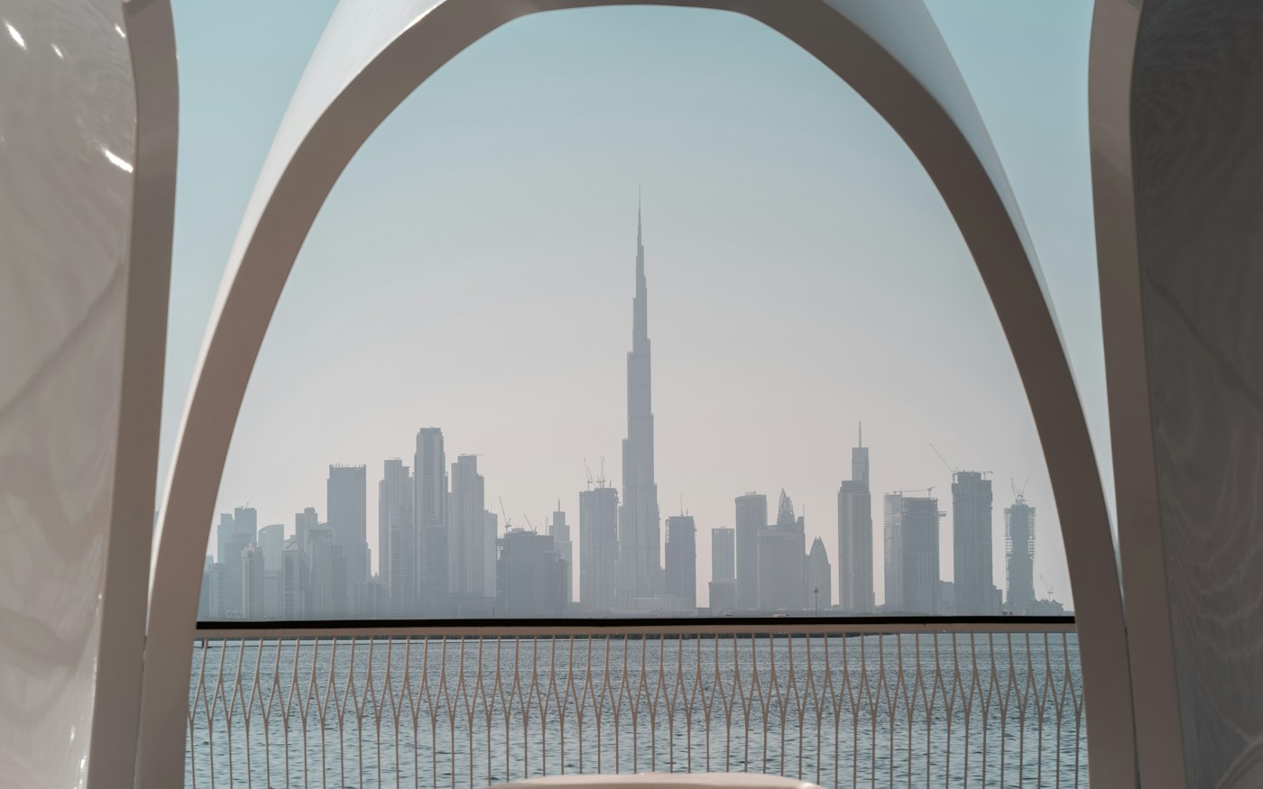 The Burj Khalifa framed by an arched terrace across the water